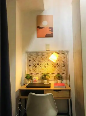 a desk with a lamp and potted plants on it at That Boho Crib 1bedroom with Balcony facing amenities in Manila
