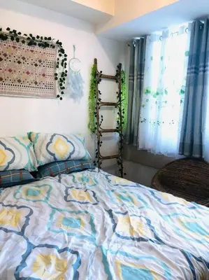 a bedroom with a bed and a window at That Boho Crib 1bedroom with Balcony facing amenities in Manila