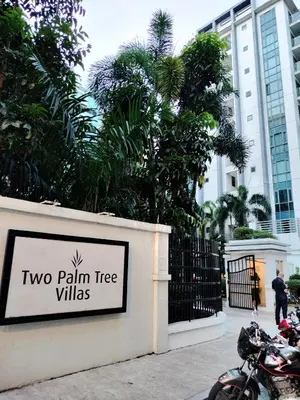 a sign for two palm tree villas in front of a building at Room Across NAIA Terminal 3 Two palm tree in Manila