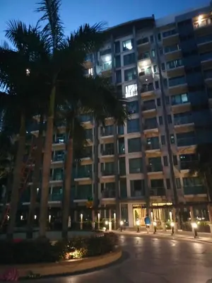 a large building with palm trees in front of it at Room Across NAIA Terminal 3 Two palm tree in Manila