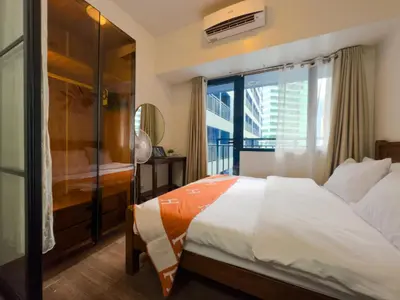 a bedroom with a bed and a large window at 1BR Makati, Air Residences M008 in Manila
