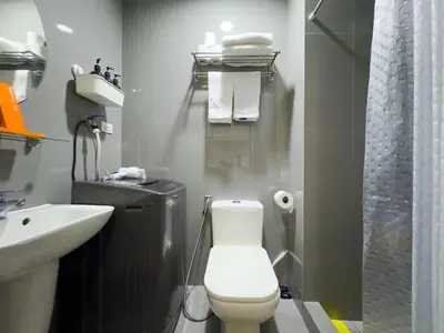 a bathroom with a toilet and a sink and a shower at 1BR Makati, Air Residences M008 in Manila