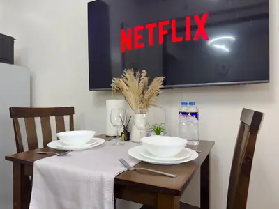 a table with two white bowls on top of it at 1BR Makati, Air Residences M008 in Manila