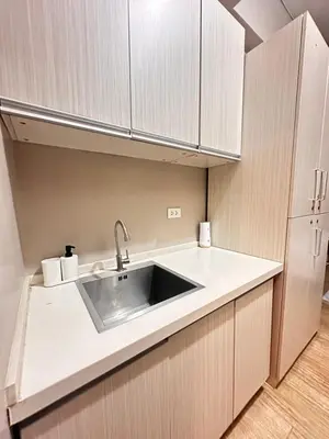 a kitchen with a sink and a refrigerator at S&Rs Place Space taft condominium in Manila