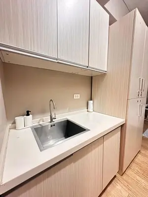 a kitchen with a sink and a refrigerator at S&Rs Place Space taft condominium in Manila
