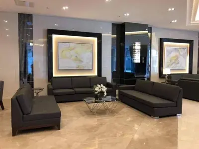a living room with two couches and a table at Fame Residences Mandaluyong 1 BR with two Big TV with Balcony in Manila