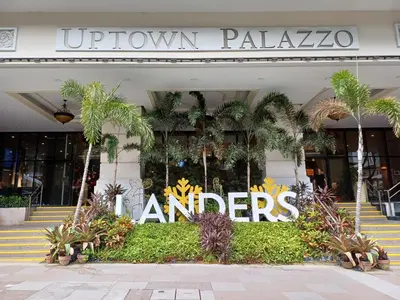 a building with a sign that reads uptown palazazos at BGC High Rise, Uptown Mall Link, 5G WiFi, Pool, Ste 29 in Manila