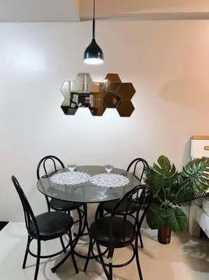 a dining room table with chairs and aendant light at The Serenity Studio in Manila