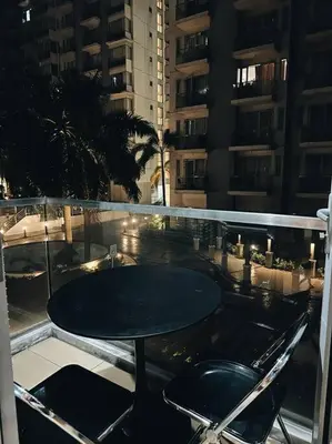 a black table and two chairs on a balcony at The Serenity Studio in Manila