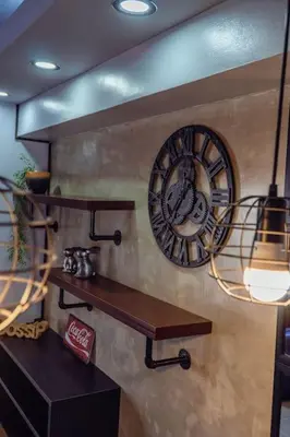 a clock on the side of a wall with a shelf at Comfy and Cozy Retreat in Manila with a Stunning View in Manila