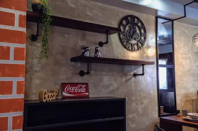 a coca cola sign on a wall with a clock at Comfy and Cozy Retreat in Manila with a Stunning View in Manila