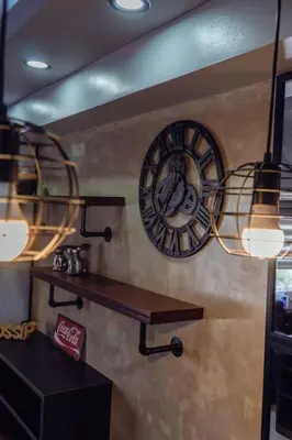 a clock on a wall with a shelf and lights at Comfy and Cozy Retreat in Manila with a Stunning View in Manila