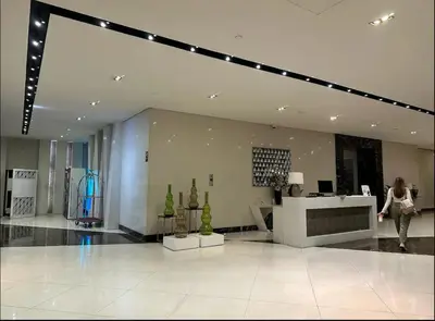 a woman walking through a building with a store at Studio in Eastwood Fast Wifi Free Pool & Gym in Manila