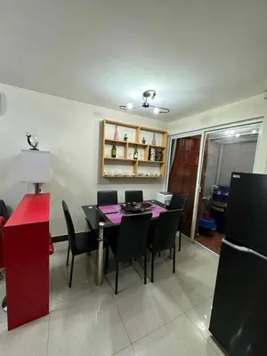 a dining room with a table and chairs at bendetto residences in Manila