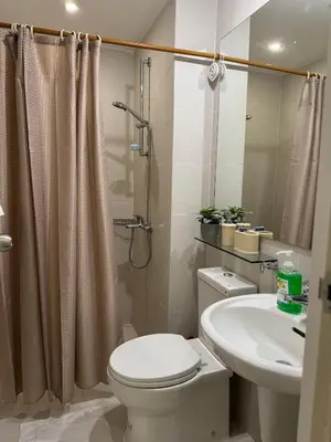 a bathroom with a toilet and a sink and a shower at Dwell at Azure Urban Resort Residences Bahamas Tower in Manila