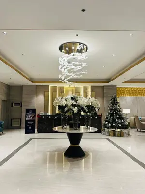 a lobby with a christmas tree and a table with flowers at Casa ni Yanyan at Fame Residences in Manila