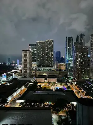 a city skyline at night with tall buildings at Casa ni Yanyan at Fame Residences in Manila