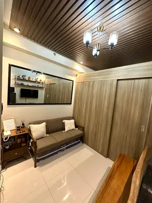 a living room with a couch and a table at Casa ni Yanyan at Fame Residences in Manila