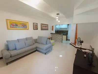 a living room with a couch and a tv at JeSa's Serenity Sanctuary in Dasmariñas