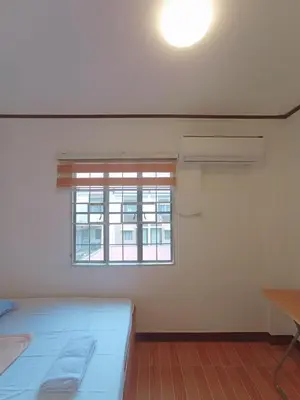 a white room with a bed and a window at JeSa's Serenity Sanctuary in Dasmariñas