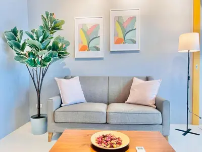 a living room with a couch and a table at One Uptown Residence BGC in Manila