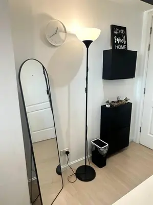 a mirror in the corner of a room with a lamp at El Spacio Azure 1BR with PS4 & Netflix in Manila