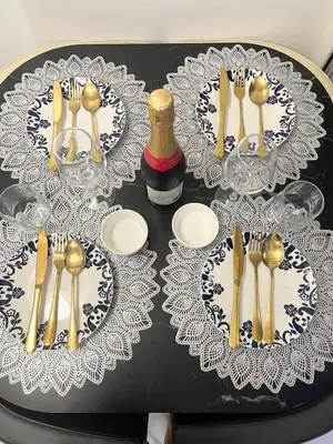 a table with plates and gold forks and spoons at Affordable Azure Staycation in Manila