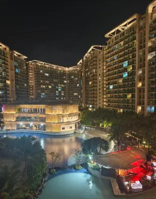 a view of a large building at night at Affordable Azure Staycation in Manila
