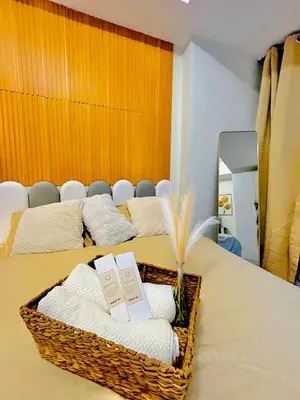 a basket of towels on a table with two beds at Casa Marix & Z - Beach View Unit in Manila