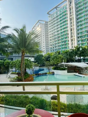 a view of a resort with a pool and palm trees at Casa Marix & Z - Beach View Unit in Manila