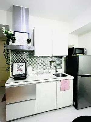 a kitchen with a sink and a refrigerator at Casa Marix & Z - Beach View Unit in Manila