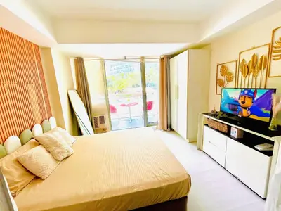 a bedroom with a bed and a television in it at Casa Marix & Z - Beach View Unit in Manila