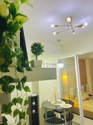 a room with a table and a bed and a mirror at Casa Marix & Z - Beach View Unit in Manila