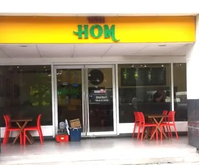 a store front with red chairs and a lion sign at Staycation at Sea Residences Suite B1202 in Manila