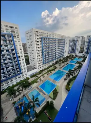 a view of a resort with a pool and buildings at Staycation at Sea Residences Suite B1202 in Manila