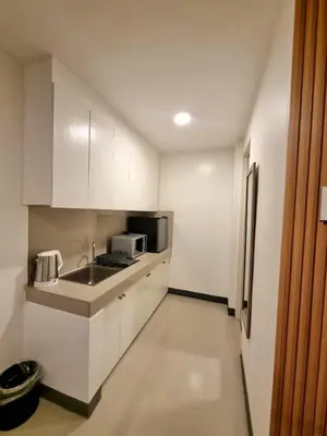 a small kitchen with a sink and a microwave at Flat 35, Unit 1E in Manila