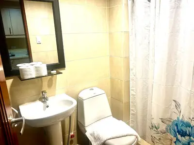 a bathroom with a toilet and a sink at 20C Staycation away from home in Manila