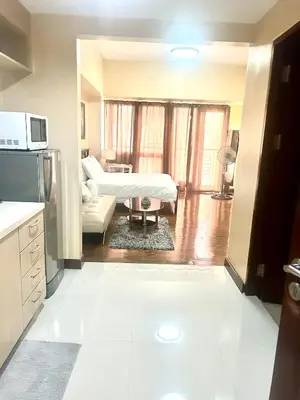 a room with a kitchen and a living room at 20C Staycation away from home in Manila