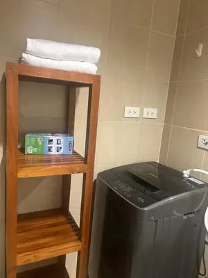 a kitchen with a stove and a shelf with towels at 20C Staycation away from home in Manila