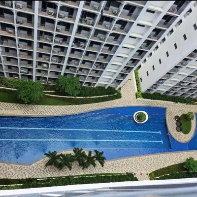 an aerial view of a large apartment building with a swimming pool at STAYCATION near MOA in Manila