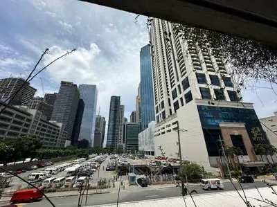 a busy city street with a lot of cars and buildings at 1br wNetflix Disneyplus and pool across SM Megamall Ortigas CBD in Manila
