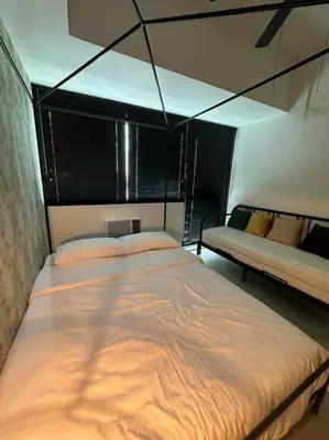a bedroom with a large bed in a room with two beds at 1br wNetflix Disneyplus and pool across SM Megamall Ortigas CBD in Manila
