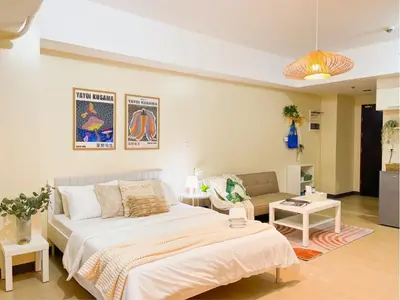 a bedroom with a large bed and a couch at Stylish 1BR Venice Mall, Pool, Fast WiFi #vlrtc17e in Manila