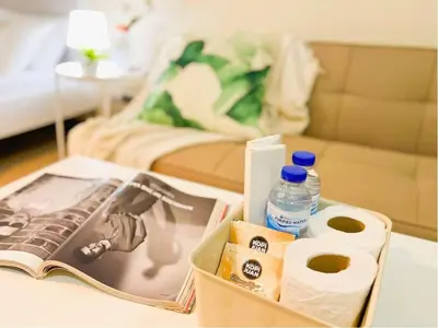 a tray with toilet paper and a magazine on a table at Stylish 1BR Venice Mall, Pool, Fast WiFi #vlrtc17e in Manila