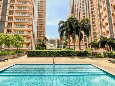 a swimming pool in a city with tall buildings at Stylish 1BR Venice Mall, Pool, Fast WiFi #vlrtc17e in Manila