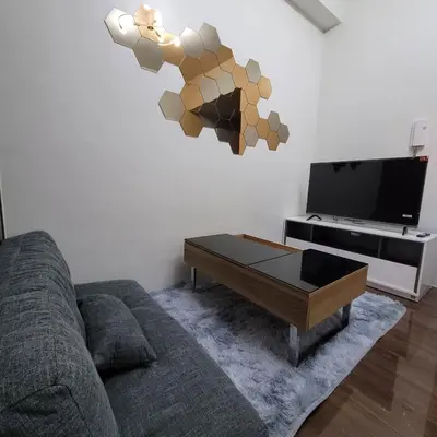 a living room with a couch and a coffee table at Air Residences - Panoramic City View near Airport - 4734 in Manila