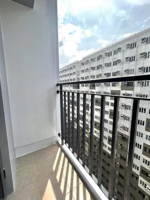 a balcony with a view of a building at Jen staycation in Manila