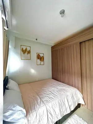 a bedroom with a bed in the corner of a room at Jen staycation in Manila