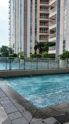 a swimming pool in front of some tall buildings at Minimalist and cozy place with balcony in Manila