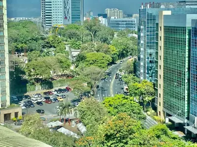 a city street with cars parked in a parking lot at Minimalist and cozy place with balcony in Manila